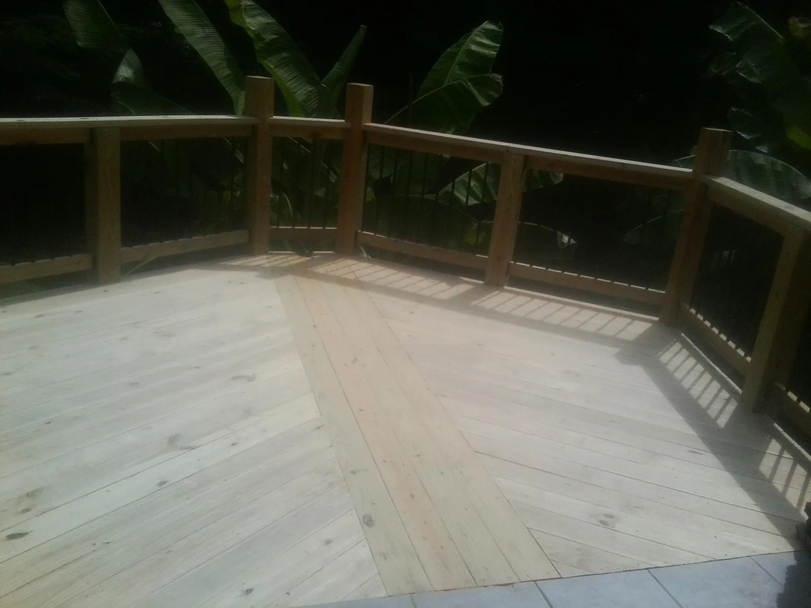New wood deck and railing built off the back of a home in Metz