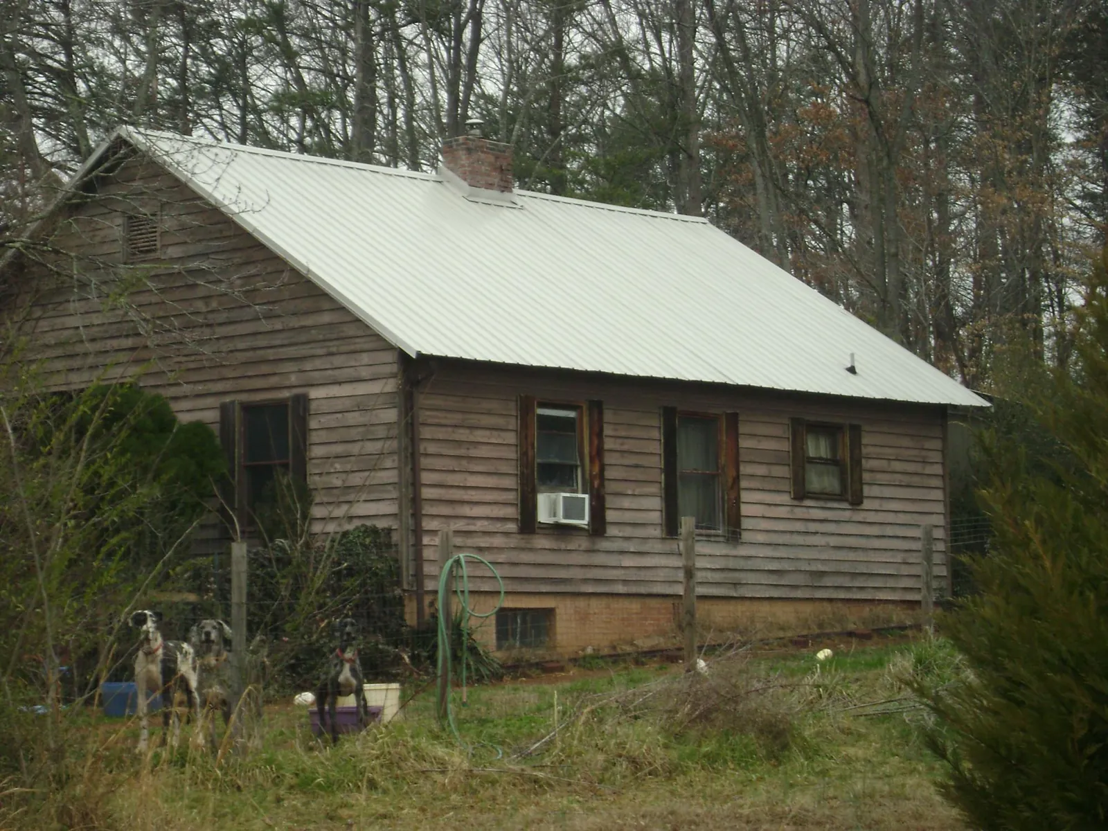 White metal roof on an old wood sided farmhouse, from a Metal Roof Installation job in Metz